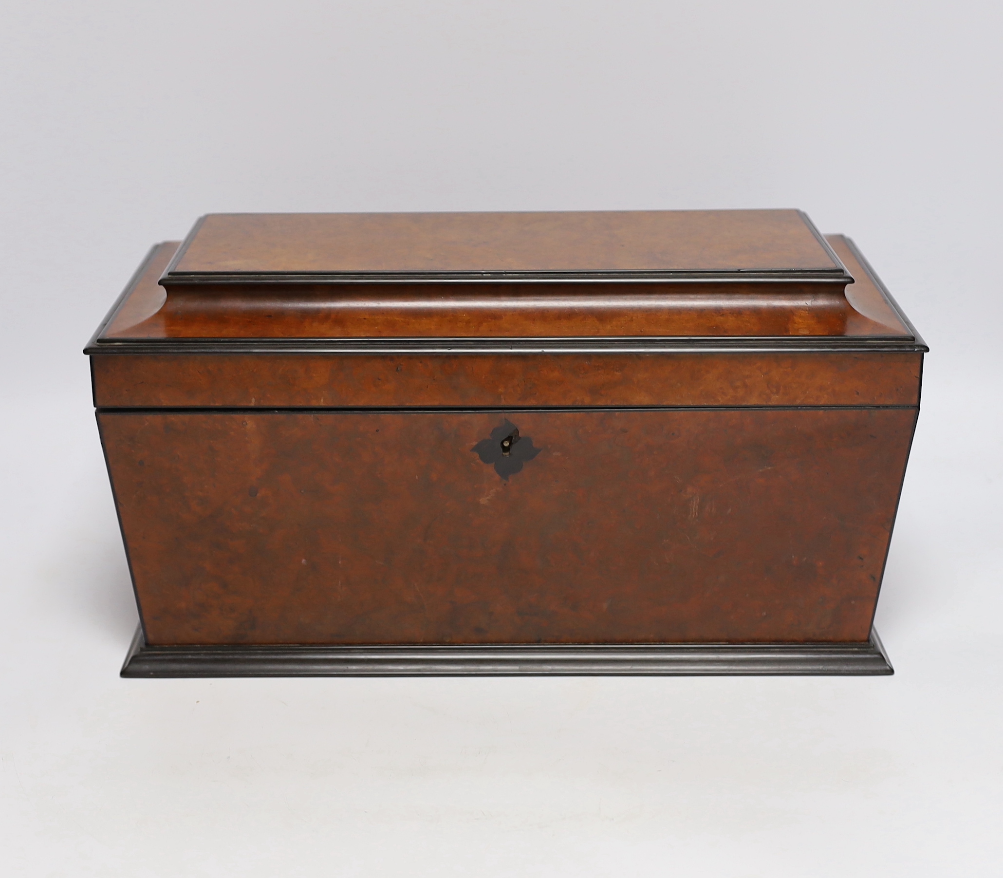 A George IV amboyna and ebony banded sarcophagus shaped tea caddy, with pedestal glass bowl, 35.5cm wide
